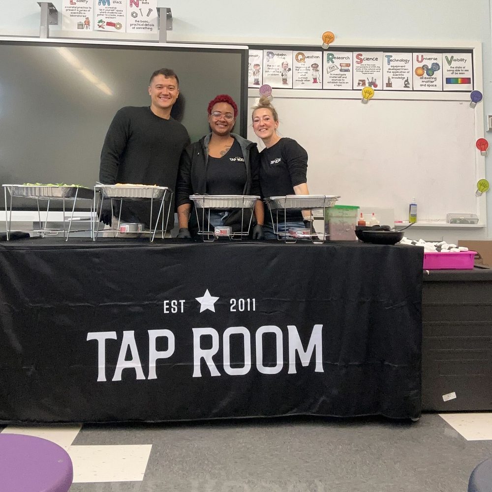 Tap Room team setting up a faculty lunch in a school classroom.