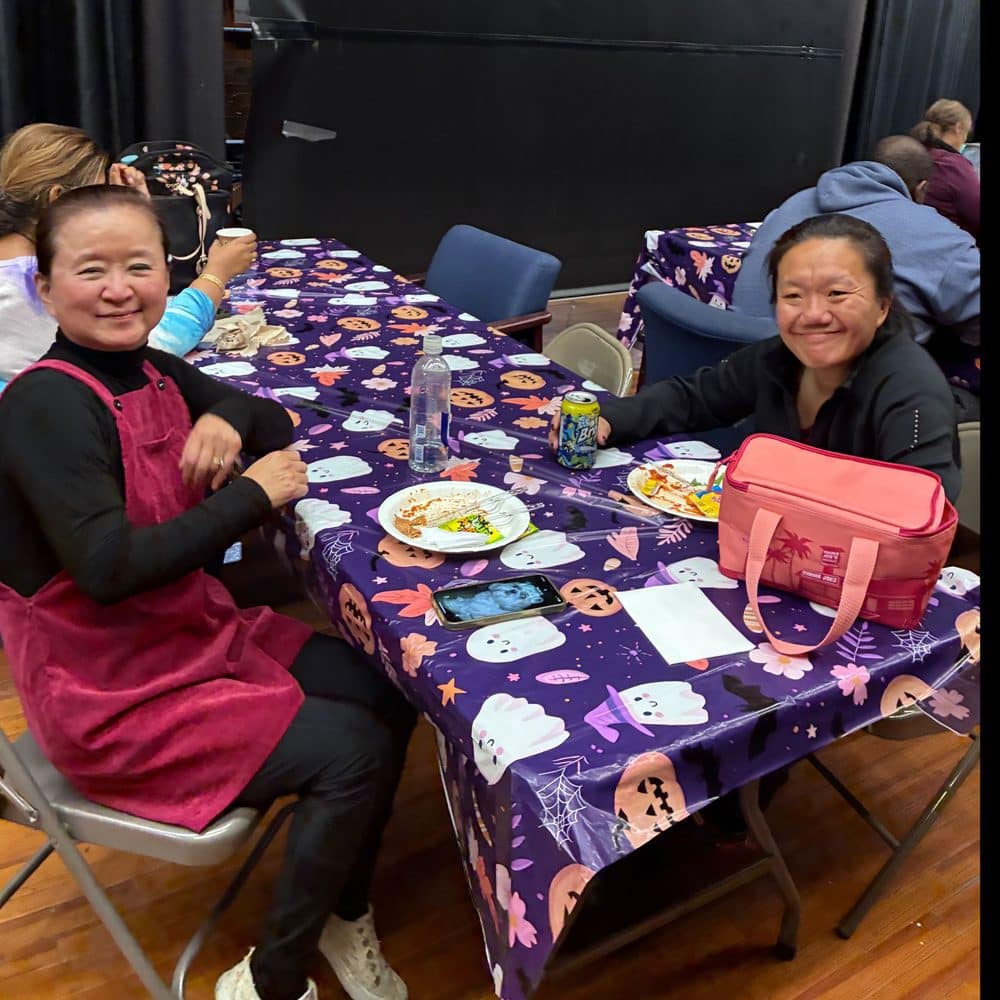 Two teachers enjoying lunch together in their school&rsquo;s faculty room.